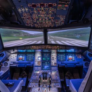 A view of the cockpit of a large commercial airplane, a cockpit trainer. Cockpit view of a commercial jaircraft cruising